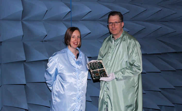 Two IRF engineers, Victoria Cripps and Walter Puccio, holding an electronics card